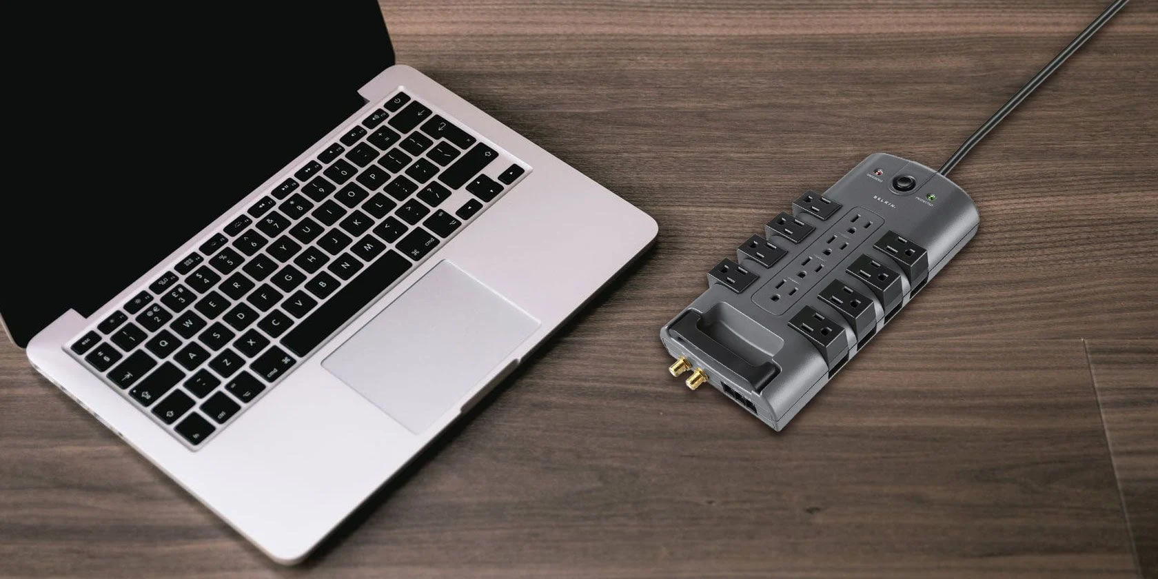 Why do I need a surge protector for my laptop?