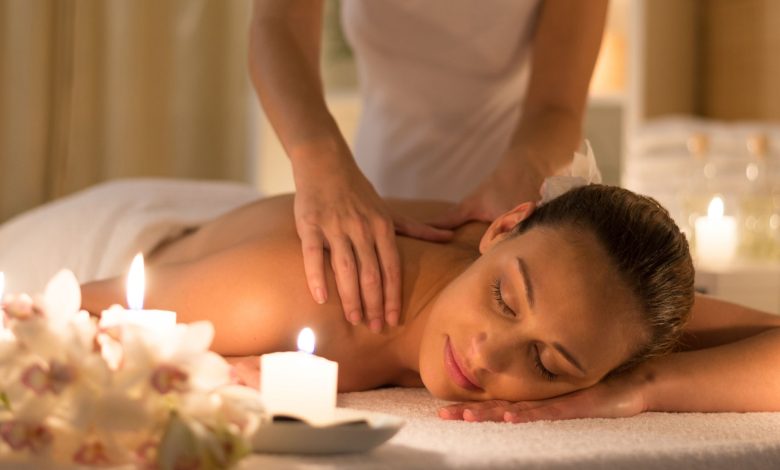 a woman taking her massage from therapists.