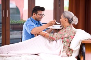 nurse feeding elderly care